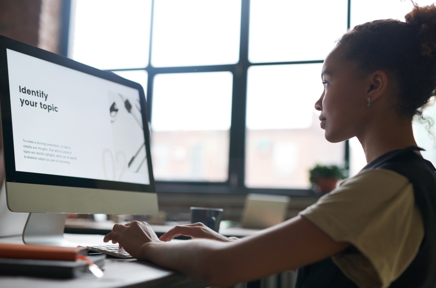 a woman sitting at a desk using a computer